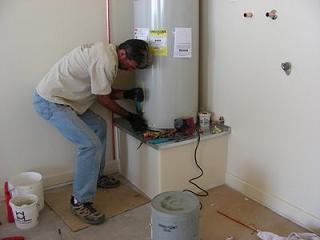 Irivng water heater repair technician reseats 40 gallon
