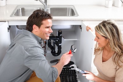 Irving TX plumber talks with a customer during a sink drain repair